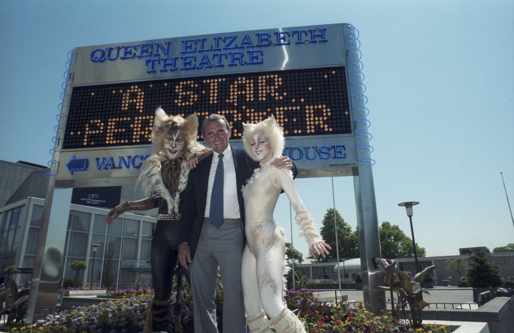 George Puil and Cats cast members in front Queen Elizabeth Theatre signboard, 1987. Reference code: COV-S477-3-F111-: CVA 775-217