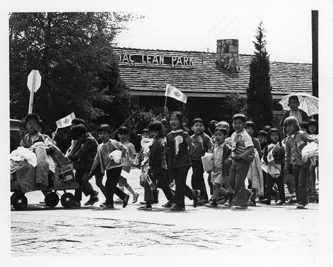 A photographic print taken by SPOTA showing a group of kids crossing the street at MacLean Park. Reference code: AM734-S4, 175-A-02 fld 05 