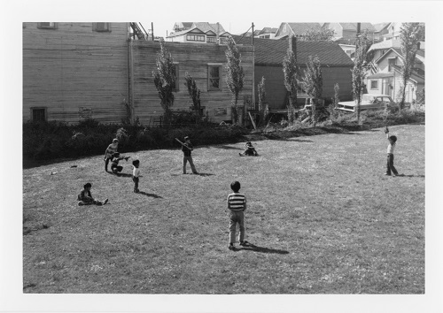 A photographic print taken by SPOTA showing children playing baseball in Strathcona. Reference code: AM734-S4 