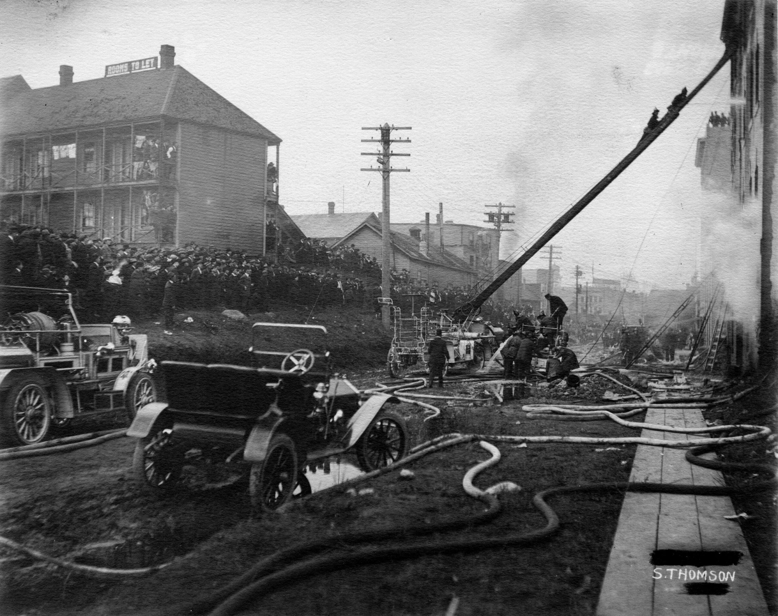 Crowds watching firefighters respond to a warehouse fire, 1910, photographer Stuart Thomson. Reference code: COV-S280-: CVA 354-018