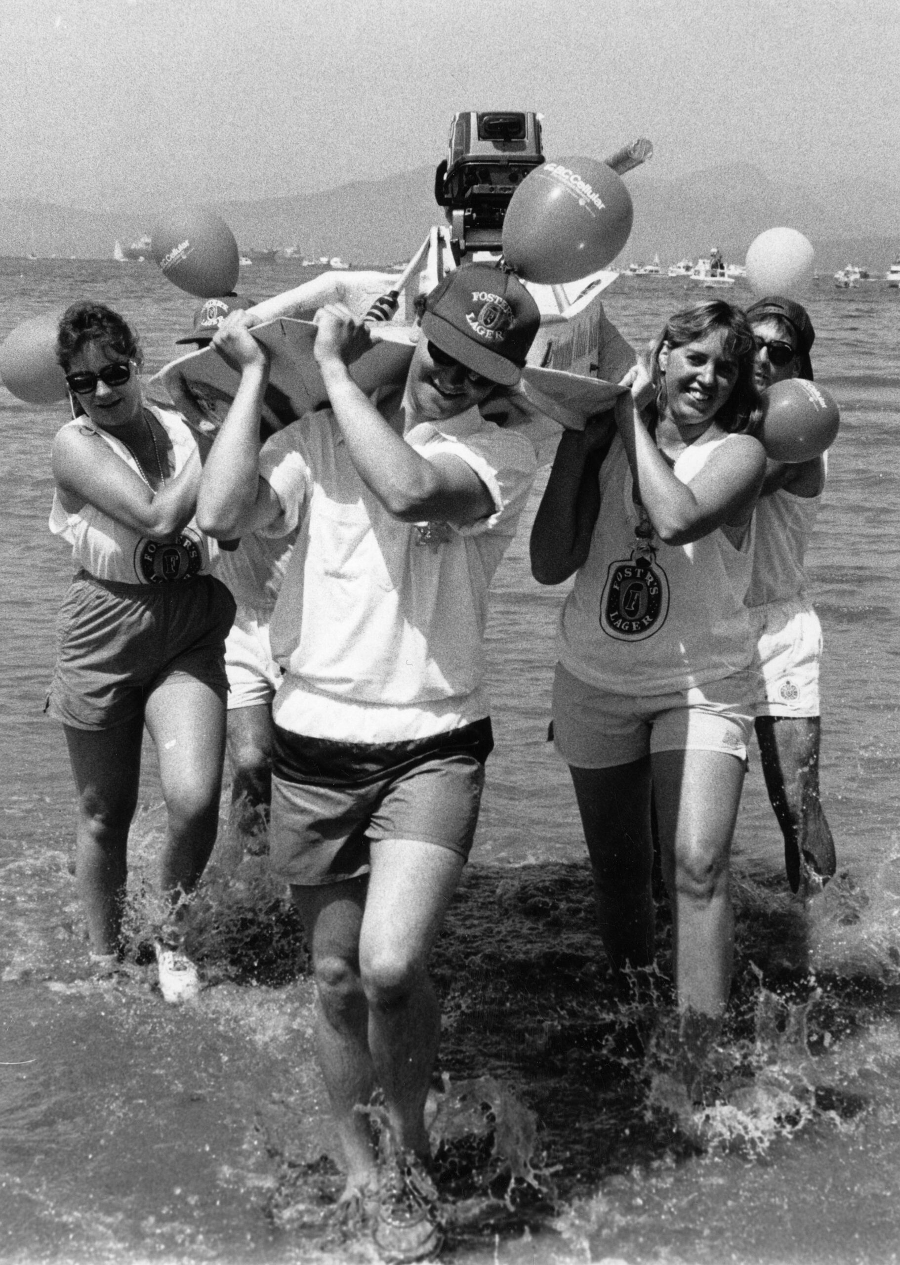 Bathtub Race participants carry tub ashore at Kits Beach finish, ca. 1990. Reference code: AM1528-S1-F158-: 2008-127.03743