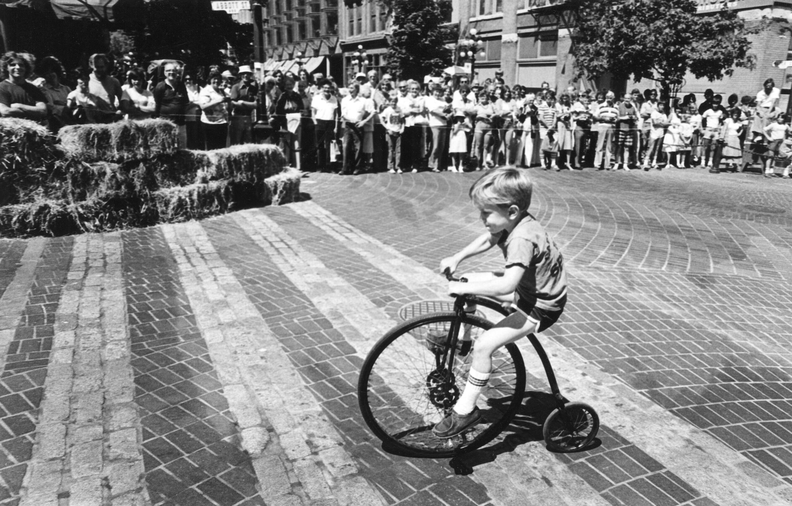 Child on penny-farthing in Gastown, 1970s. Reference code: AM1528-S1-F190-: 2008-127.05634