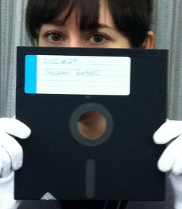 Archivist holding an 8-inch floppy disk