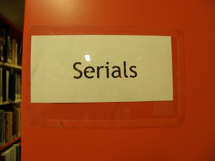 Serials sign at the end of the vintage orange shelf. Photograph by Allison Hasselfield.