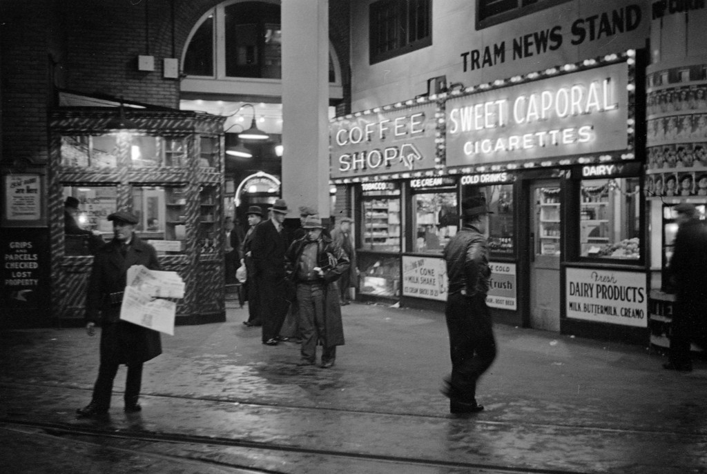 The Tram News Stand and Coffee Shop illuminated at night in the B.C. Electric Building at 425 Carrall Street, 1937. James Crookall, photographer. Reference code: AM640-: CVA 260-778 