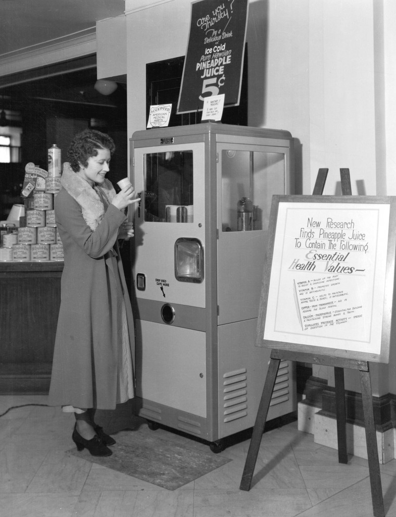 Woman using pineapple juice vending machine at the Hudson's Bay store, Sept. 20, 1933. Stuart Thomson, photographer. Reference code: AM1535-: CVA 99-4559