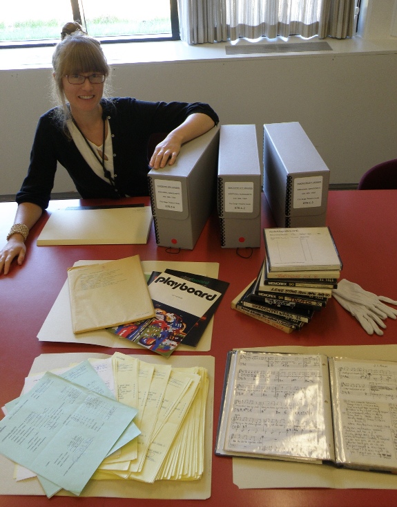 A sample from the City Stage Theatre fonds - Playboard magazines, reel-to-reel audio tapes, box office reports, and sheet music from a theatrical production. Photograph by Mel Leverich