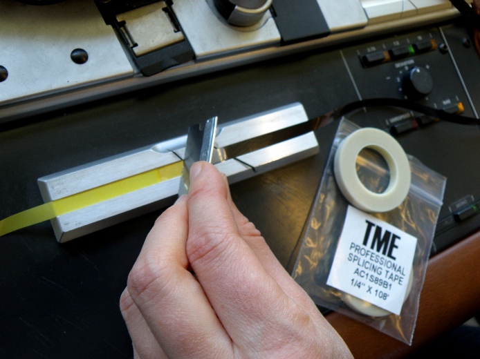 Repairing an original splice in a reel-to-reel audio tape. Photograph by Mel Leverich