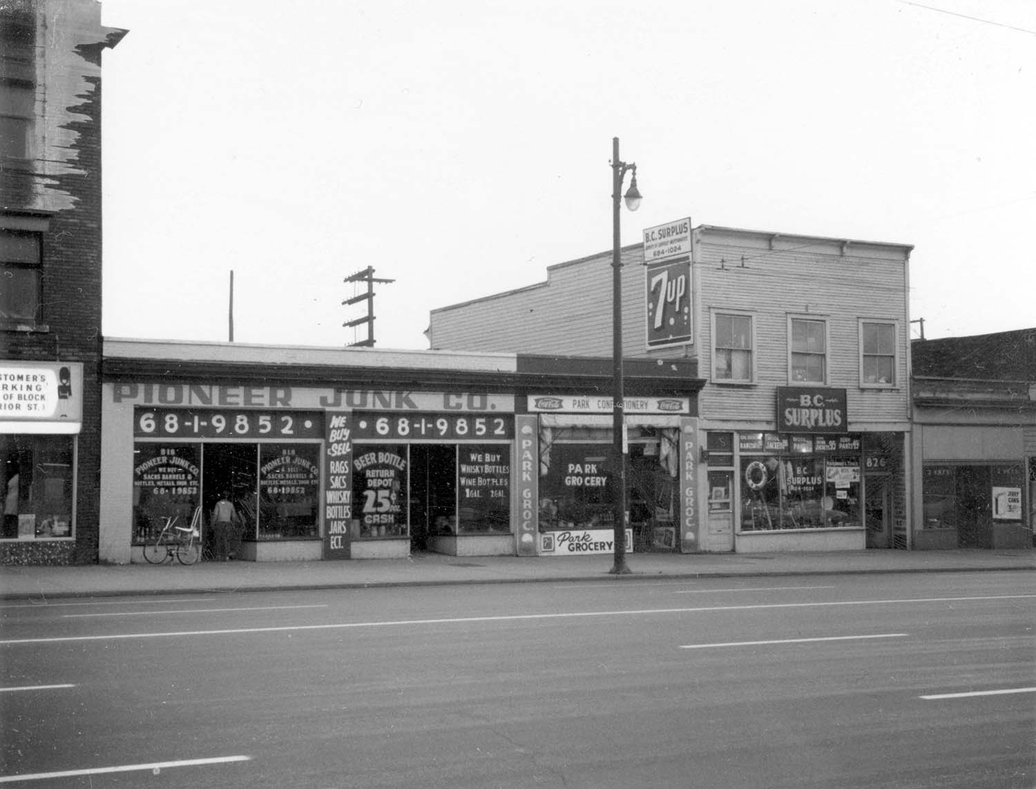 818 - 826 Main Street, 1970. Photograph shows Pioneer Junk Co. (818 Main Street), Park Grocery (822 Main Street) and BC Supplies (826 Main Street). Reference code COV-S168-: CVA 203-13