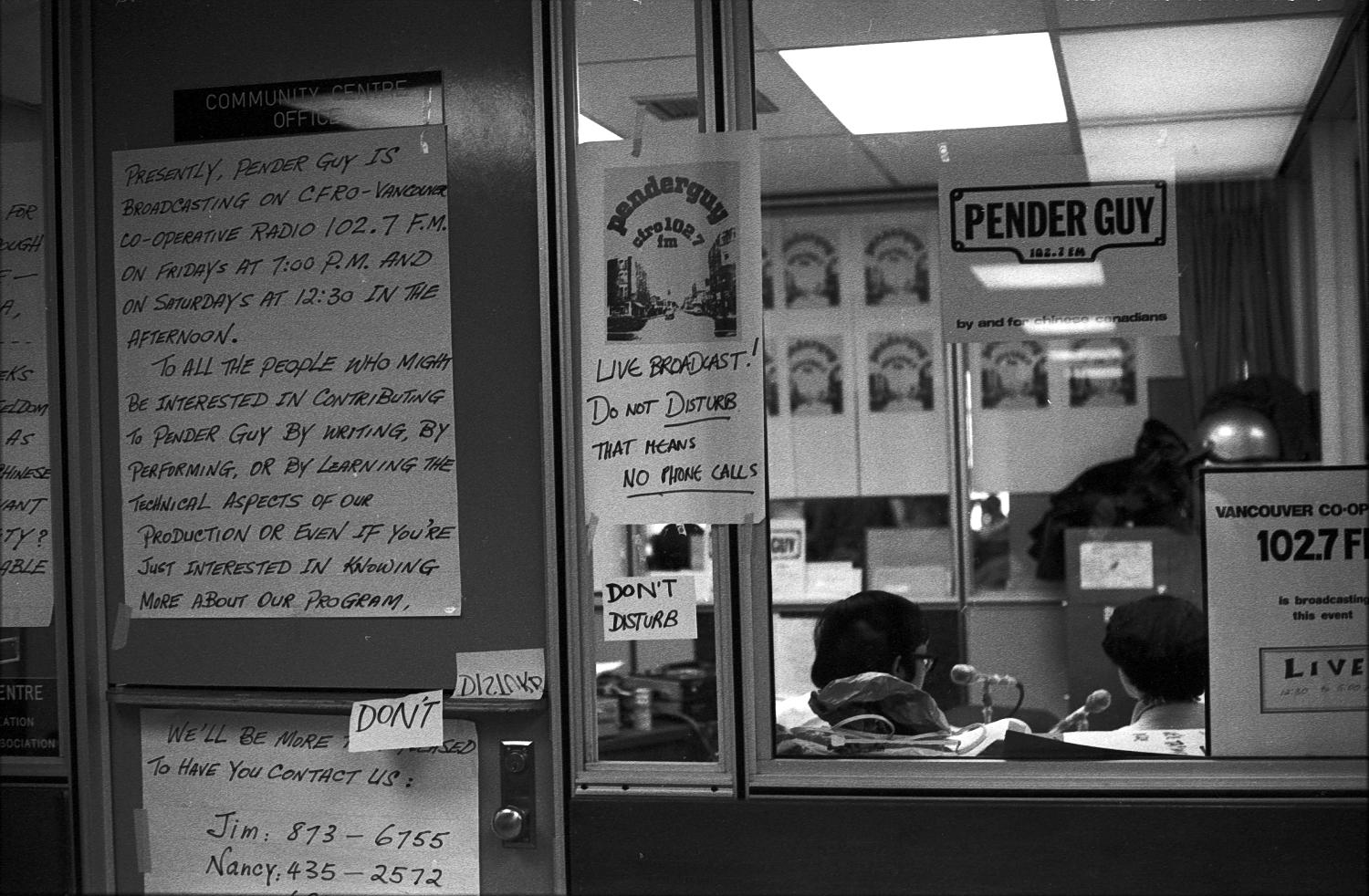 Signs outside an office at Strathcona Community Centre in which an on-air broadcast of Pender Guy was taking place, ca. 1978. Photographer: Paul Yee. Reference code AM1523-S6-F12 -: 2008-010.0999.