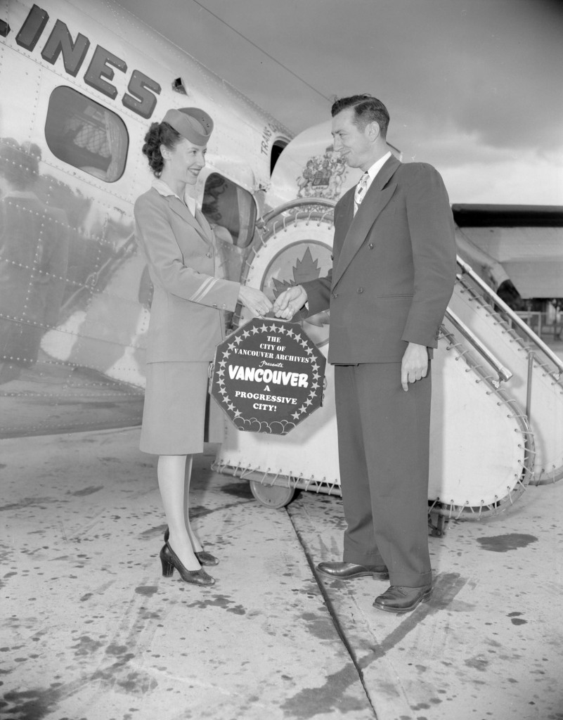 Flight attendant passing a film to a man at the airport. 1946.  Reference code: AM1184-S1-: CVA 1184-2349. Note: This photograph has been altered for promotional purposes.