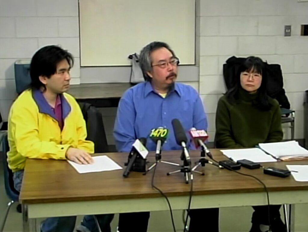 Still from a news conference on the class action lawsuit filed on behalf of Head Tax Payers, Spouses, and Descendants. L-R: Victor Wong, Sid Chow Tan, Avvy Go. Reference code: AM1698-S1-: 2023-092.1230 