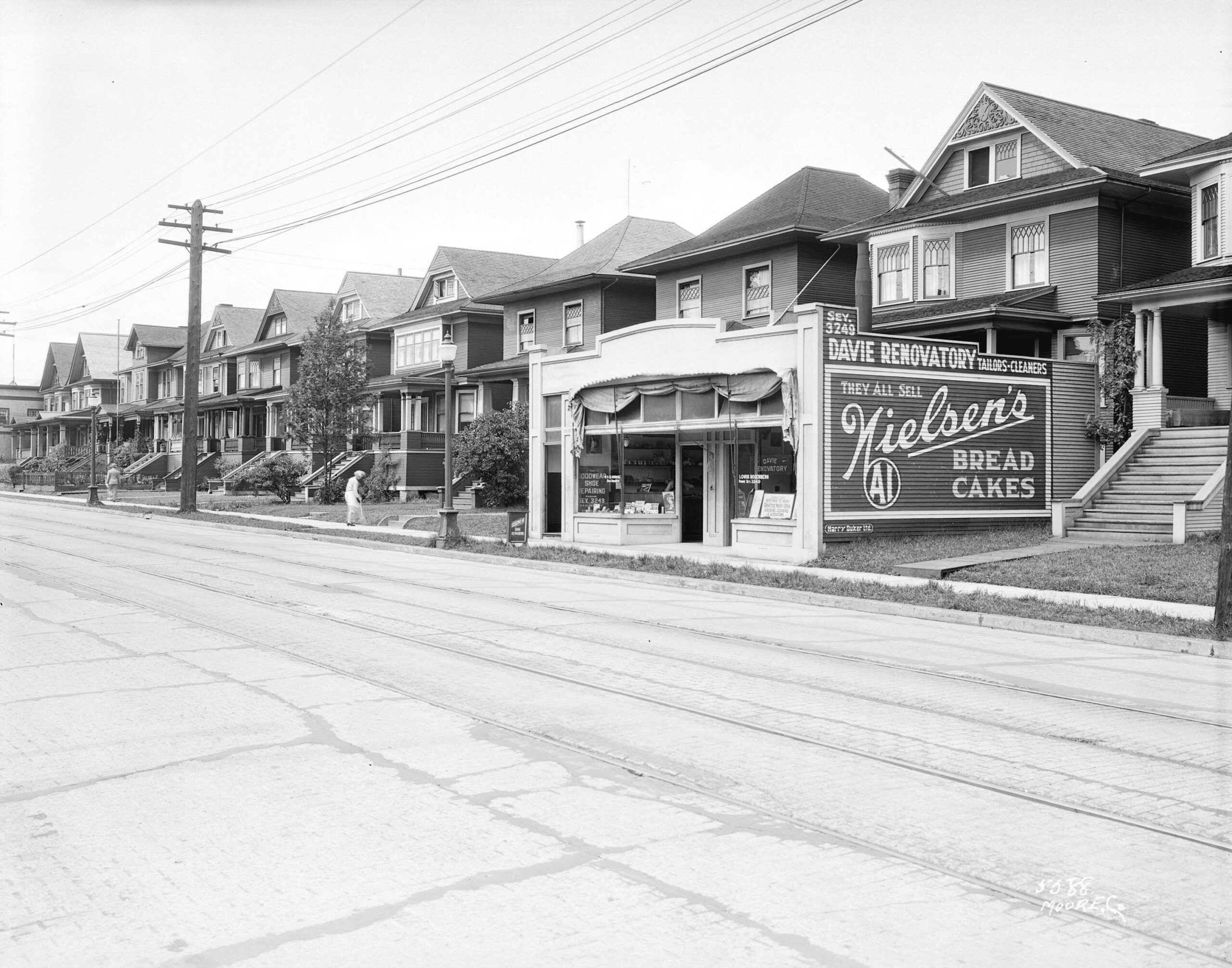A store front that appears more like a box addition to the exterior of a house on Davie Street between Thurlow and Bute Streets, 1928. Reference code: AM54-S4-: Str N266.1