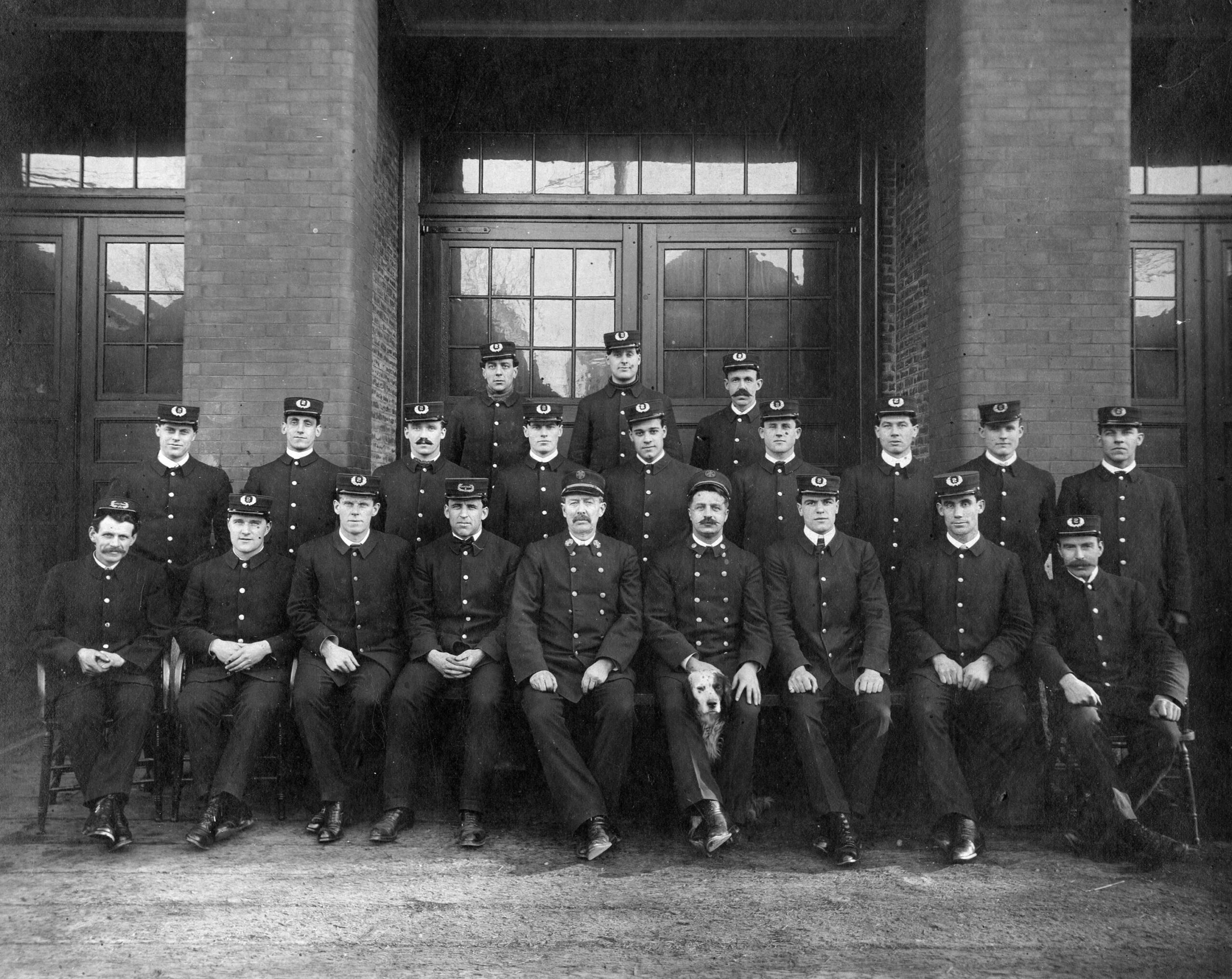 Group portrait at the No. 2 Fire Hall – complete with a pooch in the front row, ca. 1910. Reference code: COV-S280-: CVA 354-451