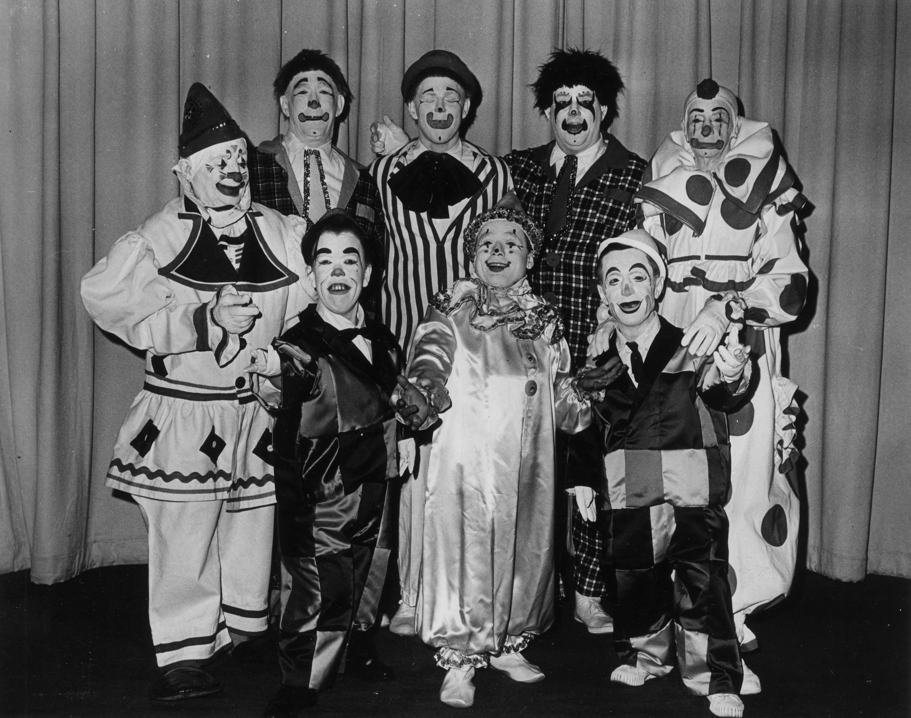 8 clowns in a group pose