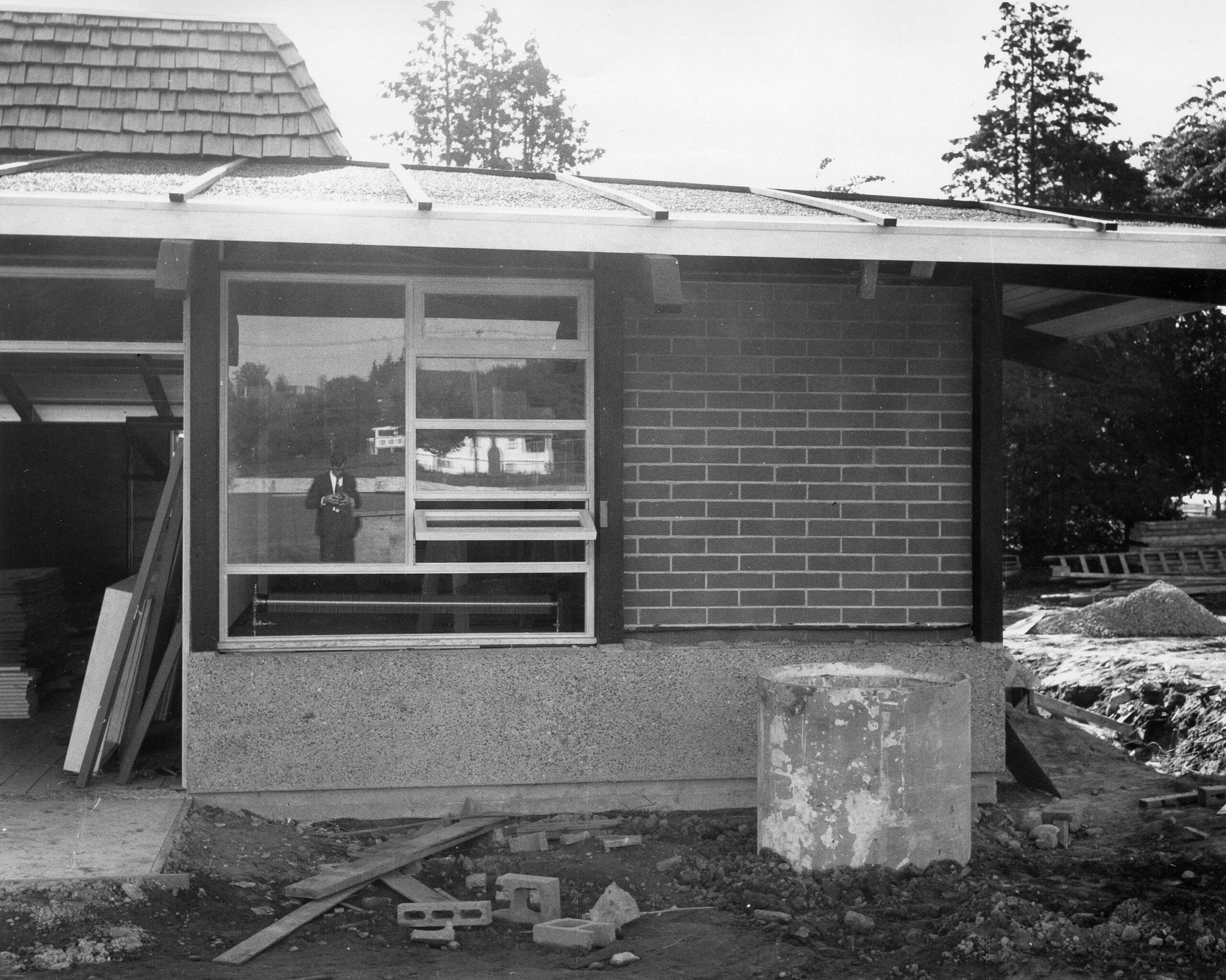 Douglas Park Fieldhouse and Community Hall under construction, 1966. The photographer can be seen in the window reflection. Reference code: VPK-S625-: CVA 392-0376