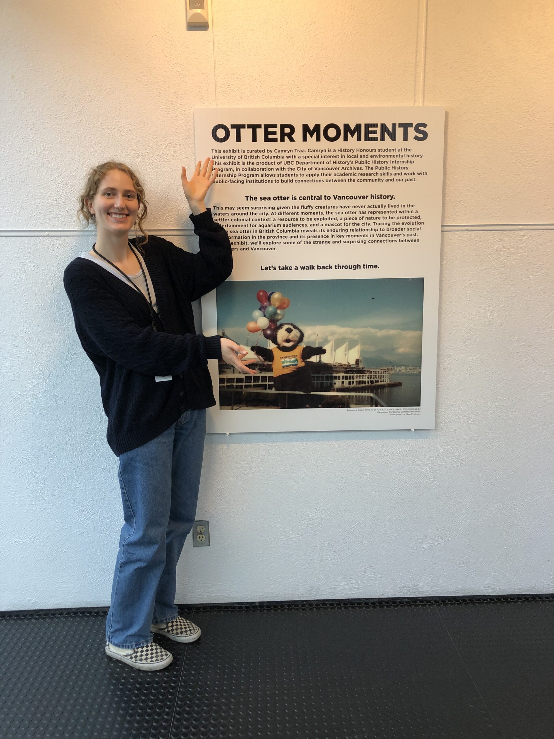 Camryn next to the first panel in her exhibit. Photo by Kira Baker.