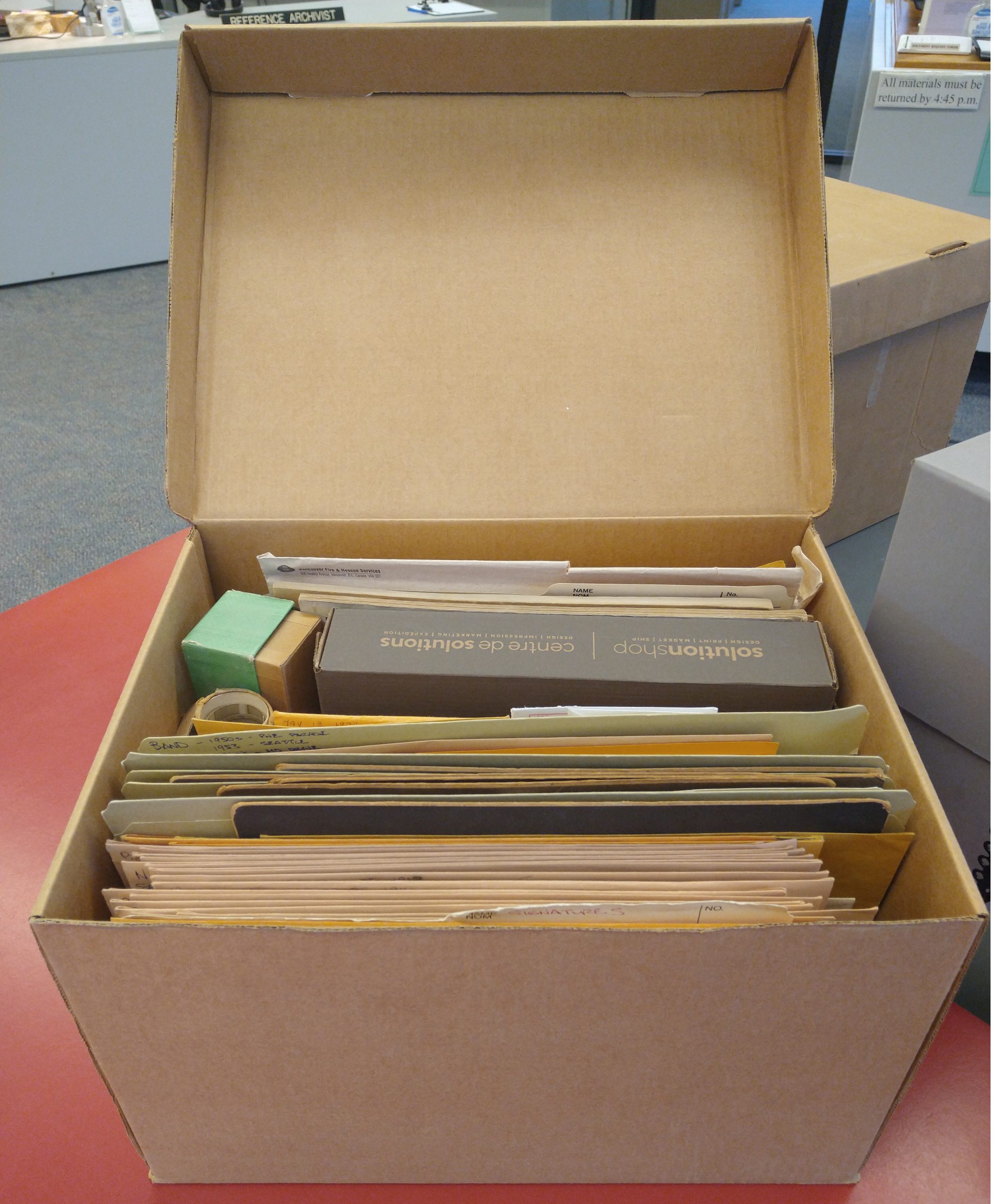 This box containing about 100+ photographic prints is awaiting further “TLC” by an archivist. Photo by Kira Baker