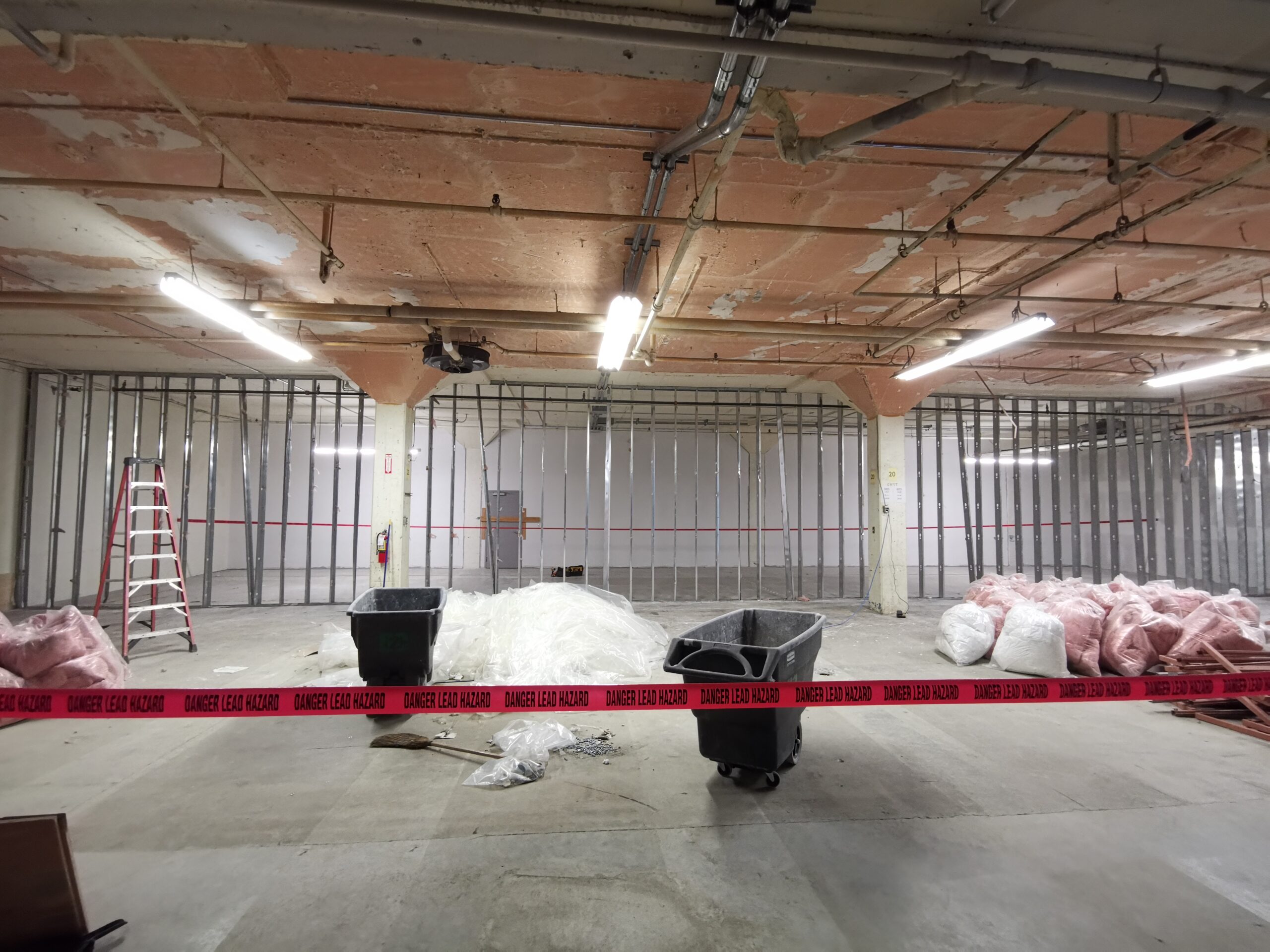 Partially demolished wall with only metal studs remaining