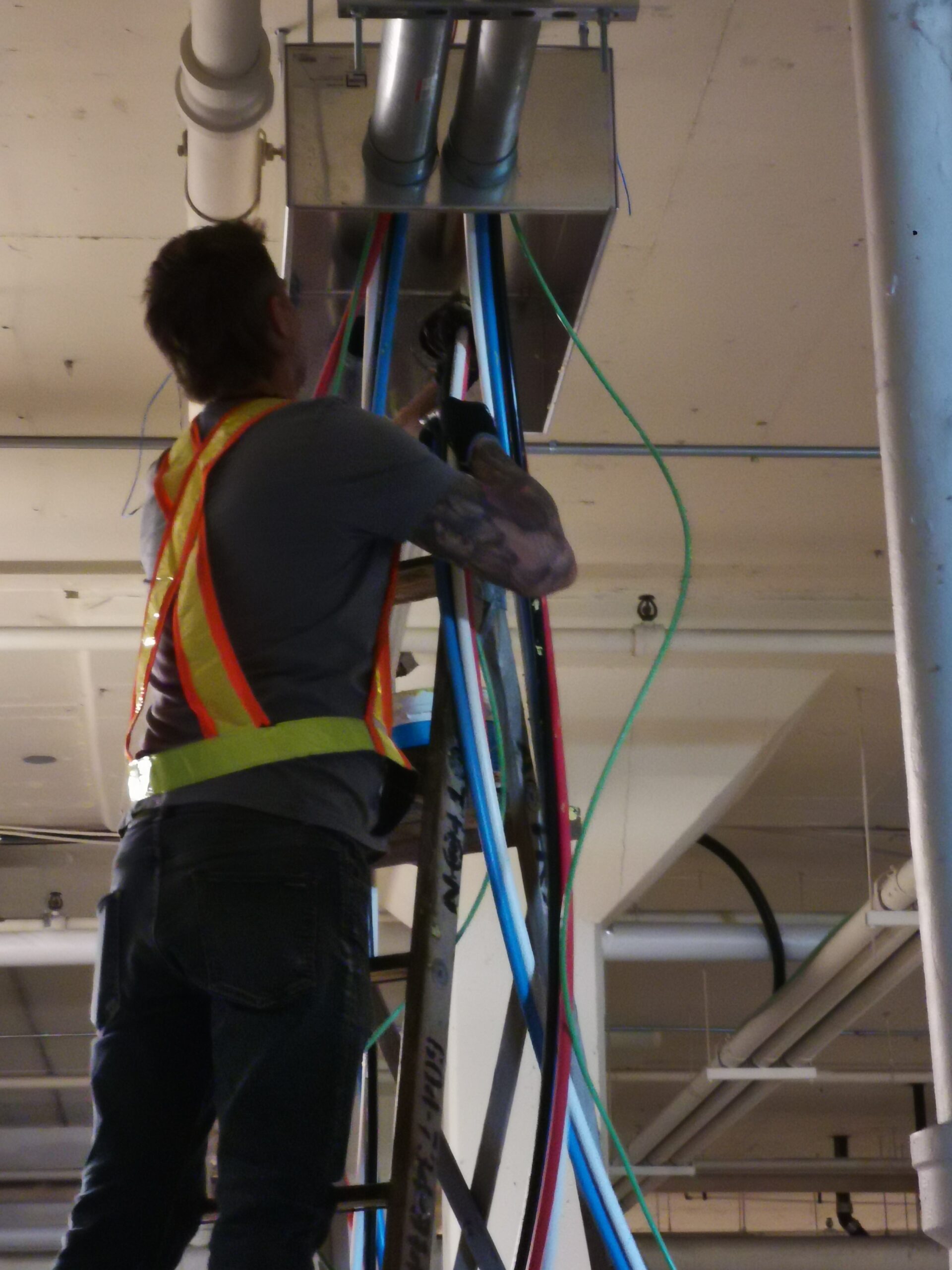 Electrician pushing cable through conduit