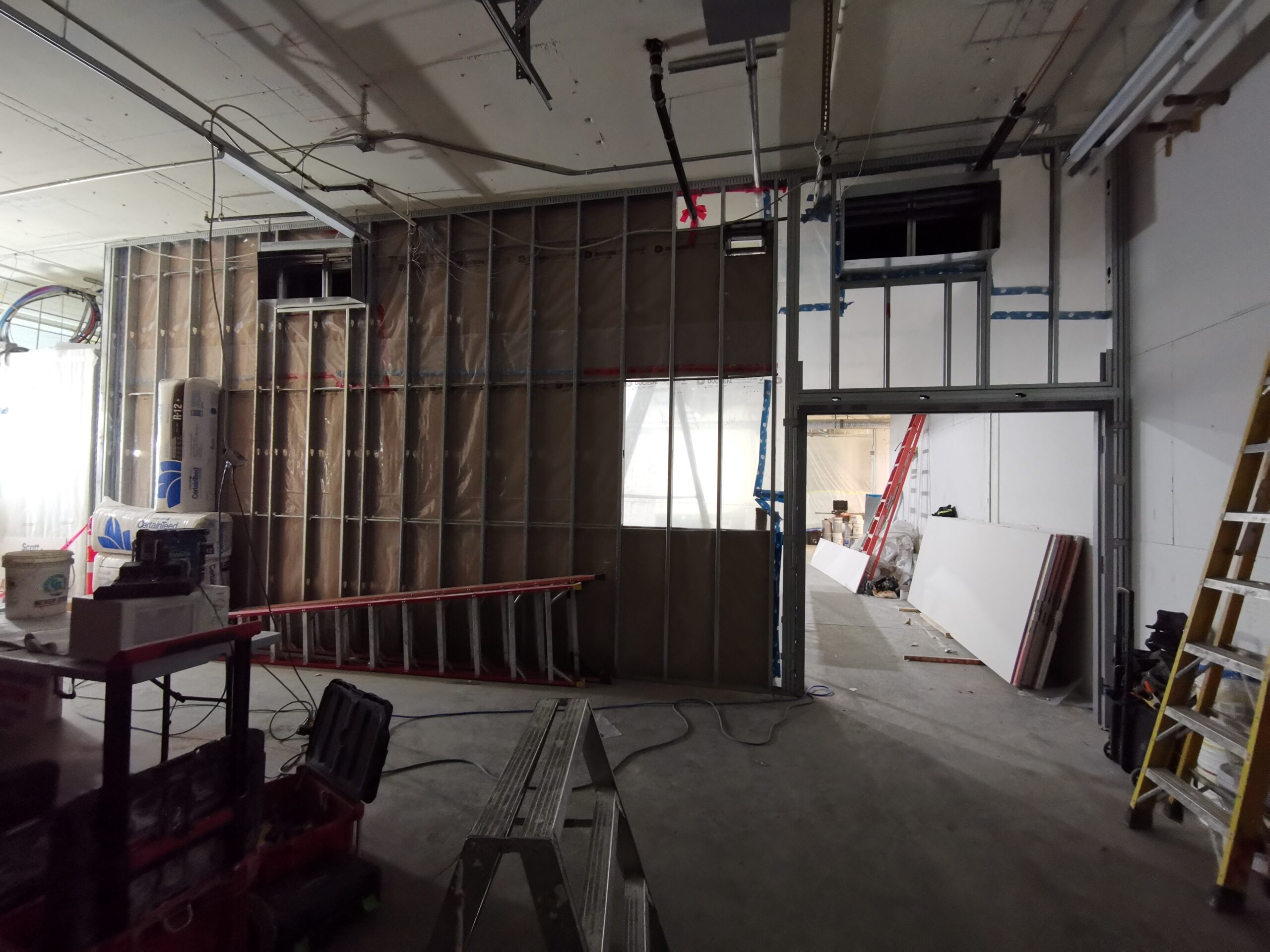 Loading bay wall being drywalled