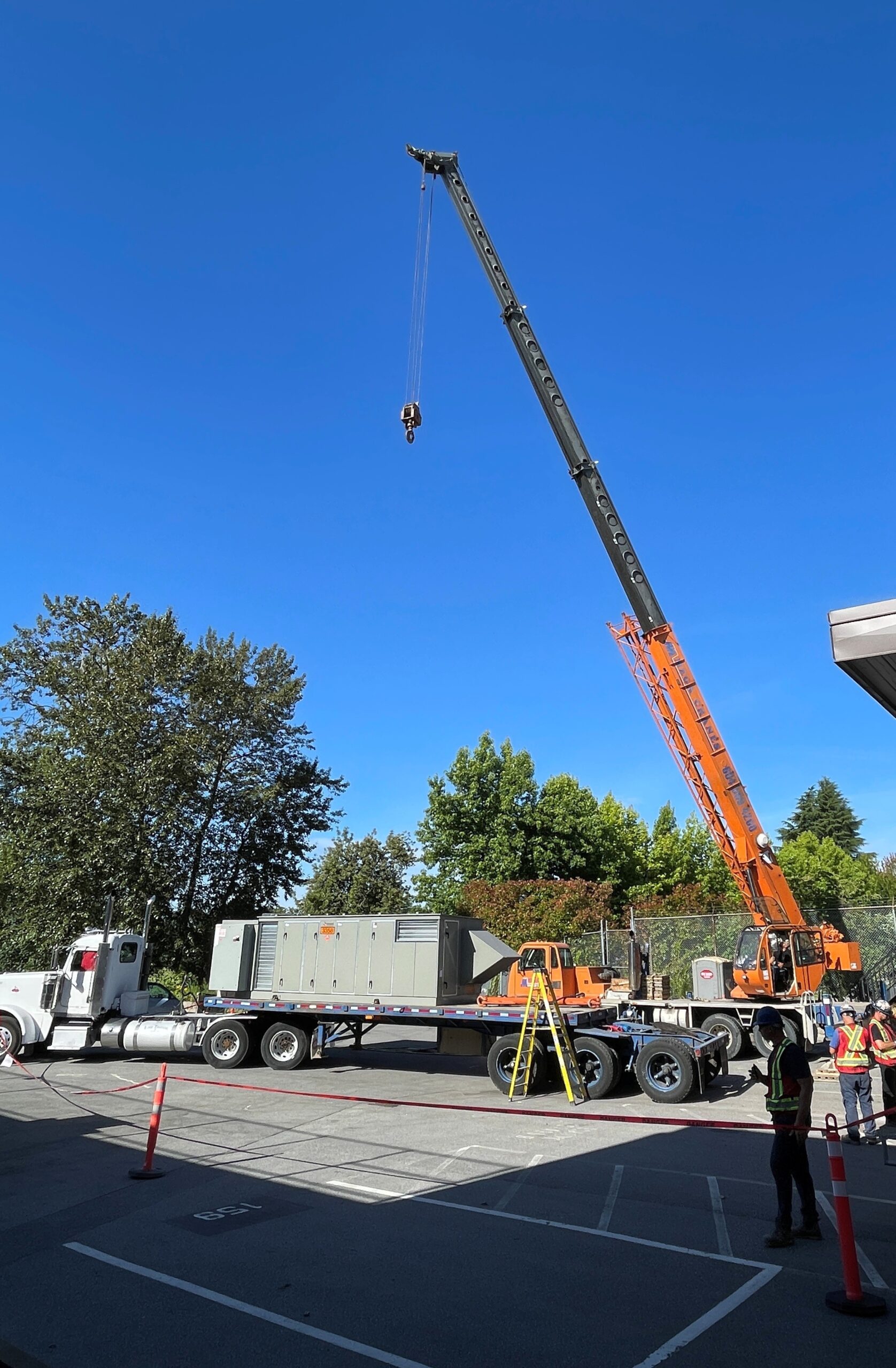 Crane about to lift air handling unit