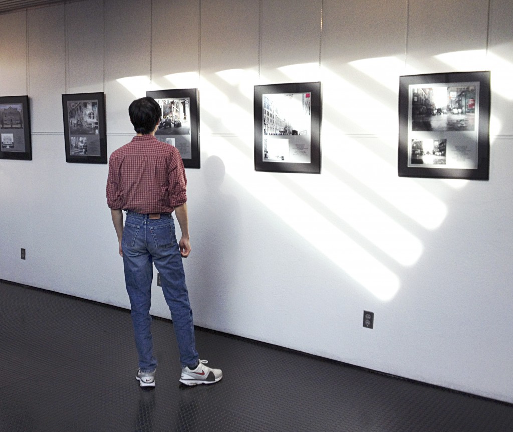 A member of the public views the Merging Time: A Modern Perspective photography exhibit. Photo credit: Christine Hagemoen.